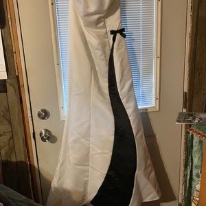 A sleeveless black and white wedding dress. Never been worn with beads on it.